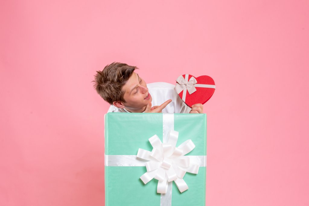 front-view-young-male-inside-present-with-gift-on-pink-background.jpg