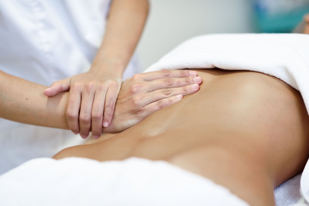 hands-massaging-female-abdomen-therapist-applying-pressure-on-belly (1).jpg